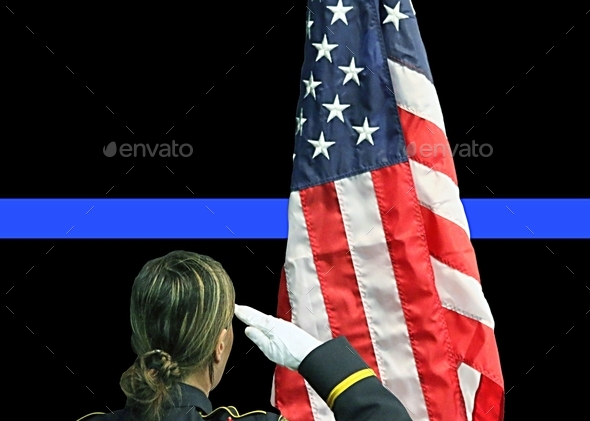 Policewoman saluting American flag with thin blue line in background.