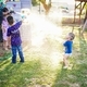 kids playing with water in the backyard with dad - PhotoDune Item for Sale