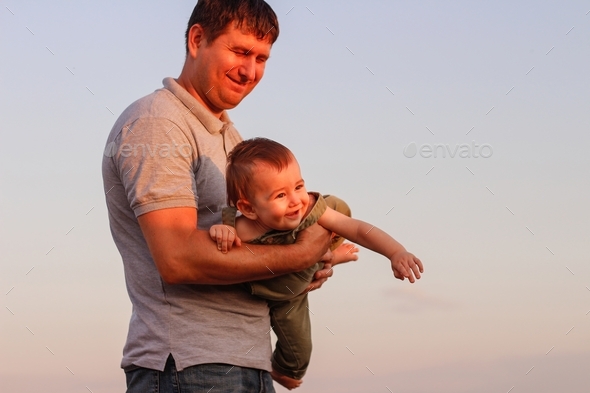 Happy Dad And Son Have Fun In The Field On A Hot Summer Day Stock Photo