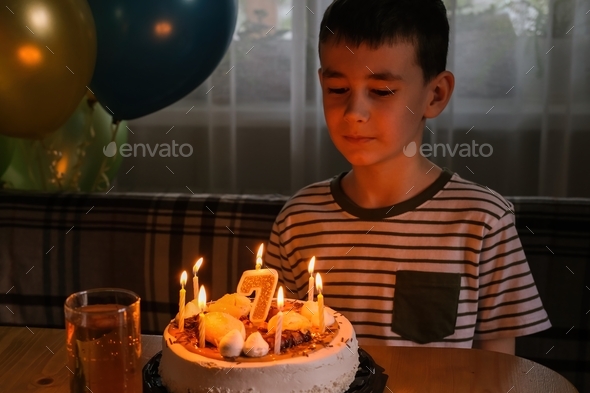 Birthday. The boy makes a wish and blows out the candles on the cake