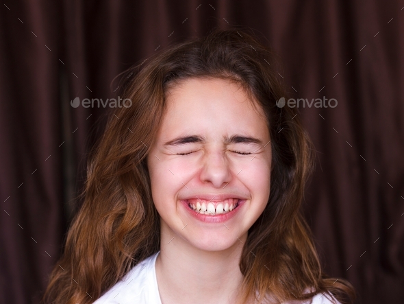 Pretty Teenager Girl With Long Hair Makes Very Funny Wface And Laughing With Closed Eyes Stock