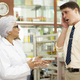A young caucasian man consults a pharmacist about his illness. - PhotoDune Item for Sale