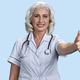 Portrait of aged woman doctor showing thumb up. - PhotoDune Item for Sale