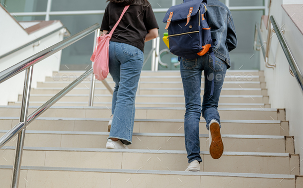 Students are walking up the stairs to the classroom.Teenager in campus ...