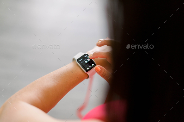 Woman checking notifications on her Apple Watch  - Stock Photo - Images