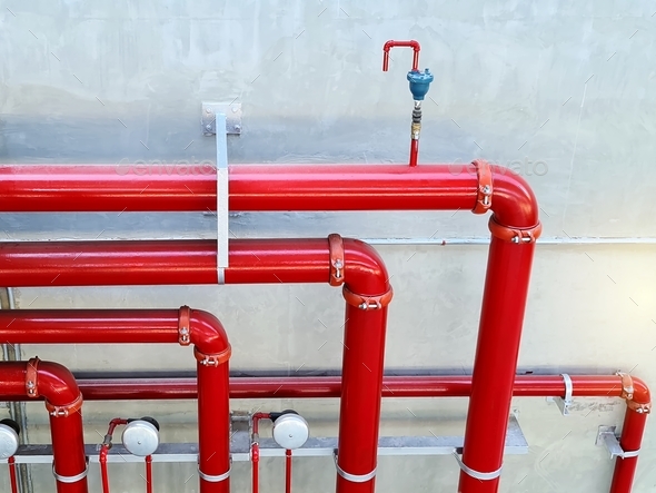 High Angle View of Red Fire Water Piping System Against Wall