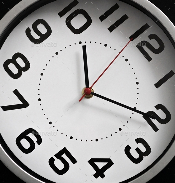 Closeup of the clock face, the concept of time management, time