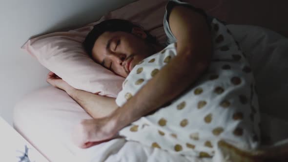 Close up of the Asian man sleeping in the bedroom at home.