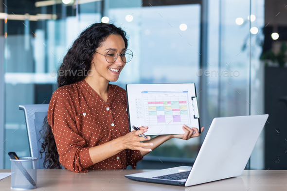 Portrait successful businesswoman, Latin American woman shows a report ...