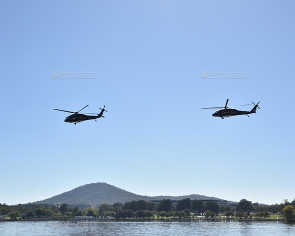 Black Hawk military helicopters on a low level flight path over Lake Burley Griffin in Canberra