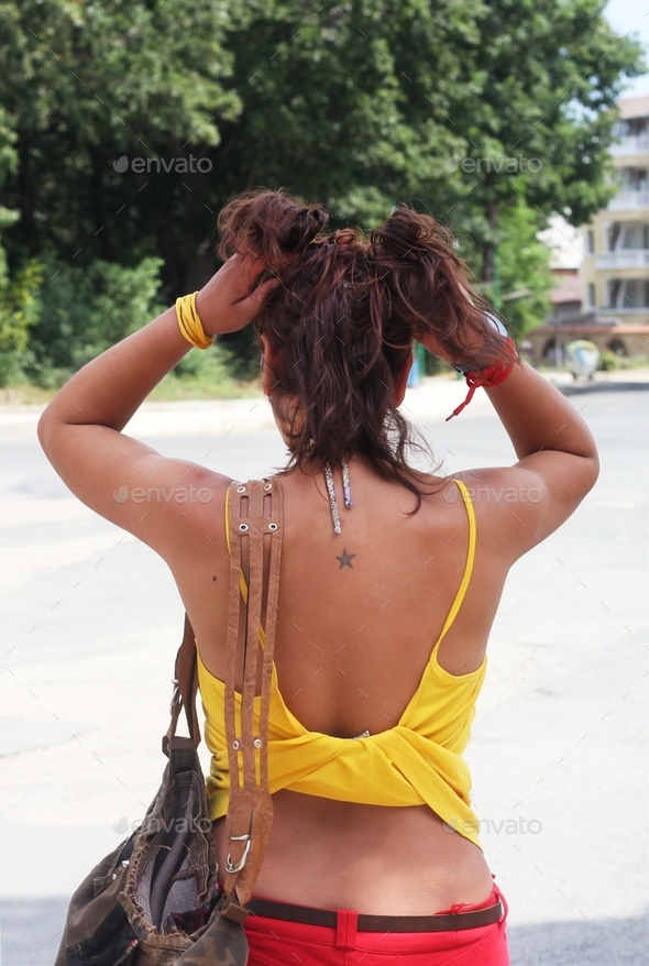 A woman from the back at the street