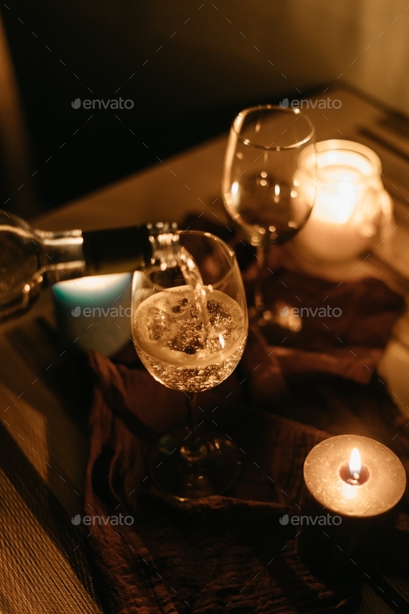 wine date at home with candles / pouring wine in a glass / romantic / love