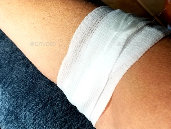 Healthcare and Medicine! A gauze bandage wraps the arm of a patient after having blood drawn.