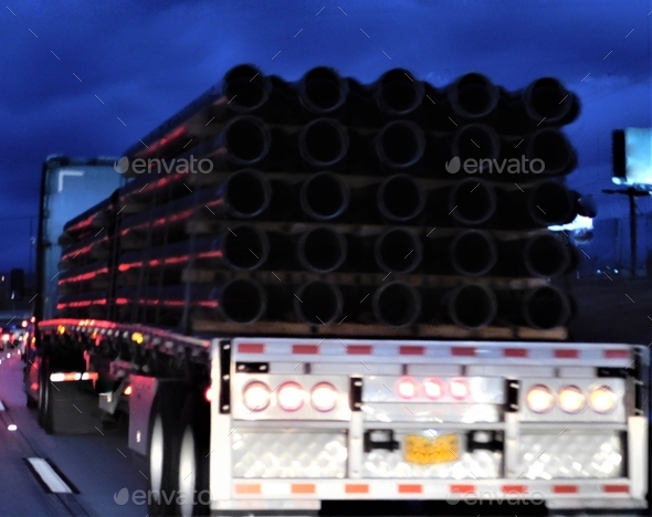 Trucking! Night Hauling! Load of Pipes! - Stock Photo - Images