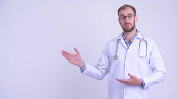 Happy Bearded Man Doctor Showing Something