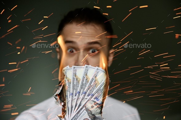 Person looking at the burning money