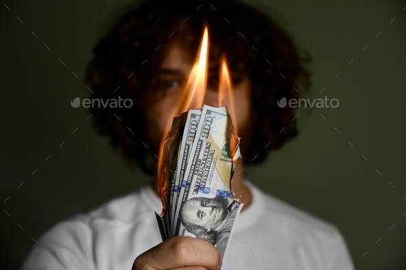 Person holding burning money