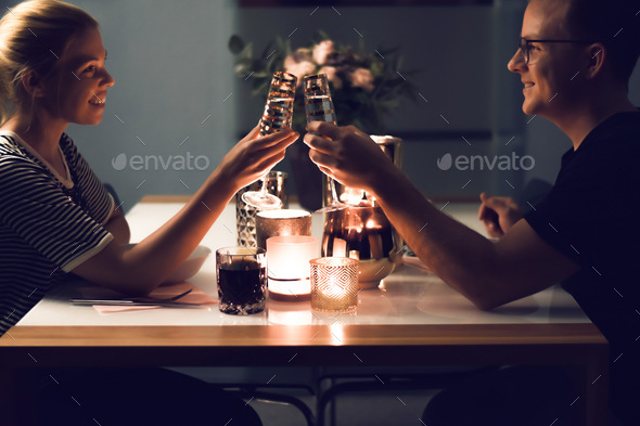 Couple enjoying romantic candlelight dinner at home