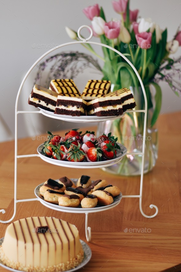 Assorted pieces of cake and pastries on a cake stand Stock Photo by