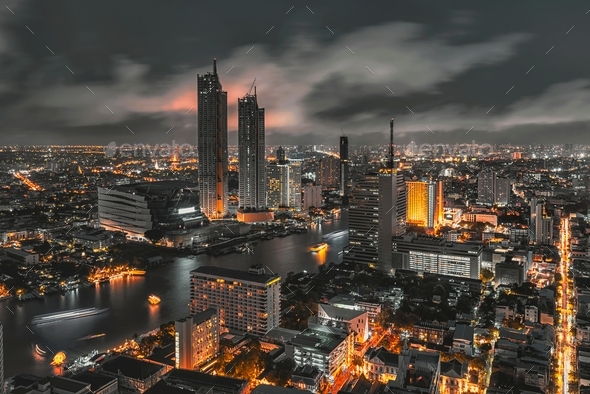 Bangkok night life with glow in the dark color tone, illuminated cityscape on skyscraper