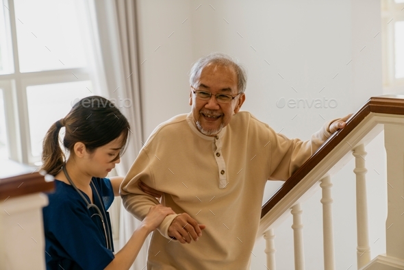 Nurse helping the elderly walk up the stairs.
