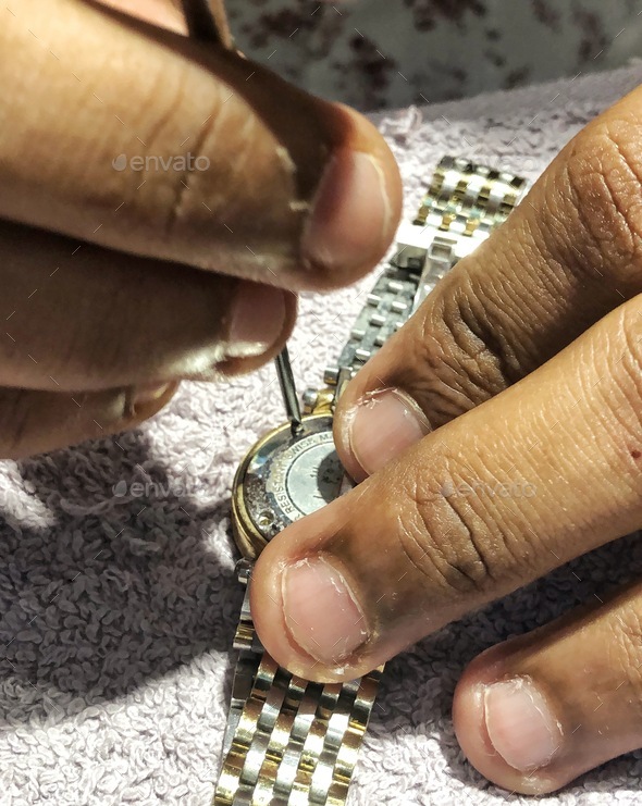 Meticulous watch repair precision fingers closeup professional tools maintenance jeweler