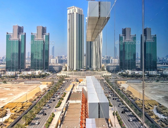 Symmetrical Cityscape Traffic comes and goes reflected in glass windows ...