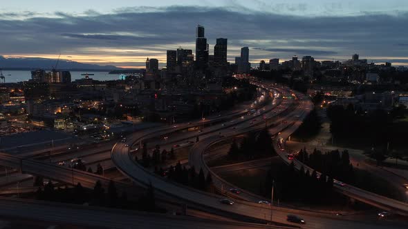 Night Aerial Of Seattle With Glowing Lights From Skyscrapers In City Skyline And Freeway Cars alt