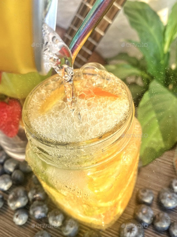Fruit Infused sparkling healthy and naturally sweet colorful summer water with eco friendly straw