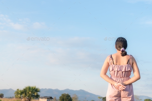 girl standing backwards and watching nature with copy space.