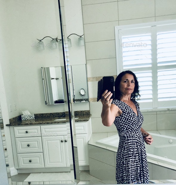 Woman taking a selfie in the bathroom.