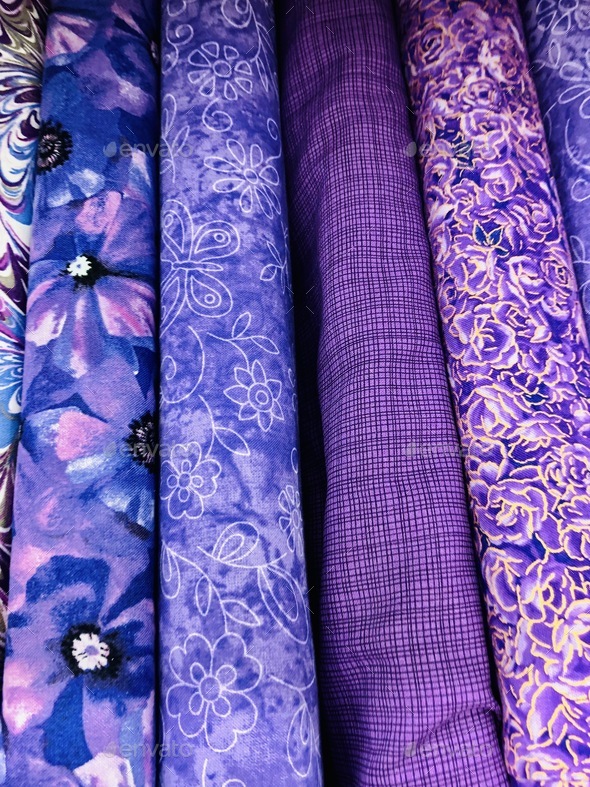 Bolts of purple colored fabrics with multiple designs and patterns ...