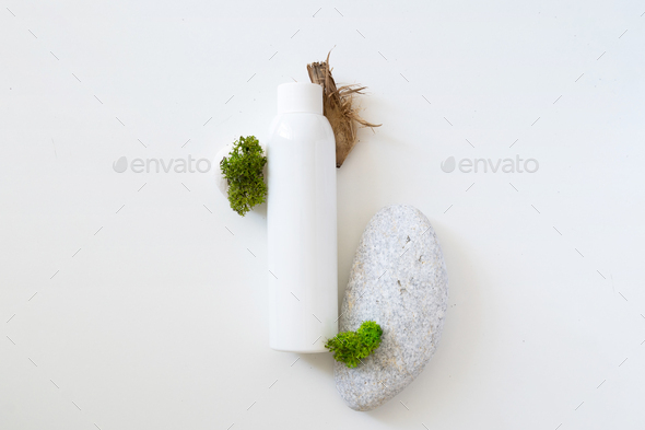 Sea moss personal care. White plastic bottle for shampoo and sea moss on white background