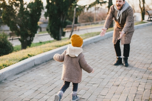 Father and his child taking a walk together in a park. Stock Photo by ...