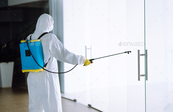 Disinfecting of office to prevent COVID-19, Man in protective hazmat ...