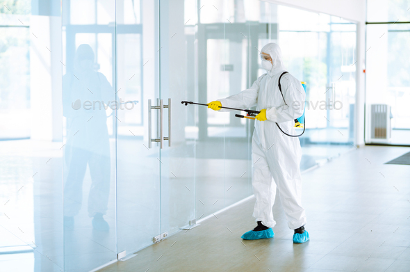 Disinfecting of office to prevent COVID-19, Man in protective hazmat ...