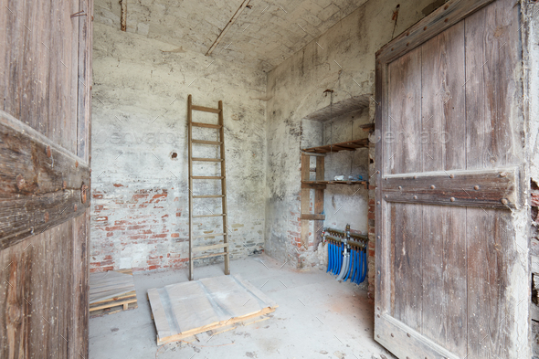 Old depository room with wooden portal in old country house - Stock Photo - Images