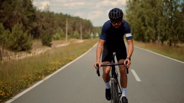 Triathlete Cyclist Training On Bicycle. Sport Recreation Workout. Fit Athlete Sport Cycling Workout alt