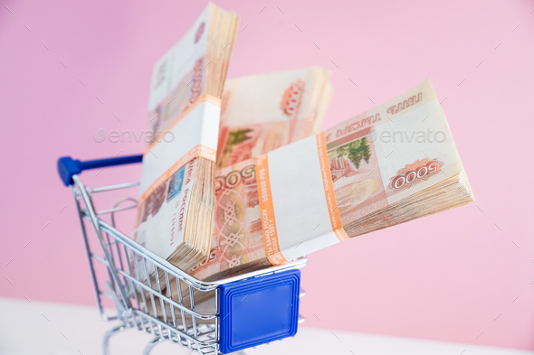 Shopping cart filled with russian money. Concept of shopping for the best deal before buying.concept