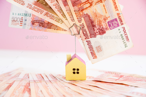 Model of the house standing on five thousand banknotes.Rental estate.Sale property template.Model of