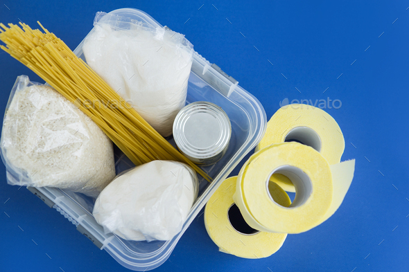 Food aid during quarantine. Container with products: sugar, rice, pasta, canned food.