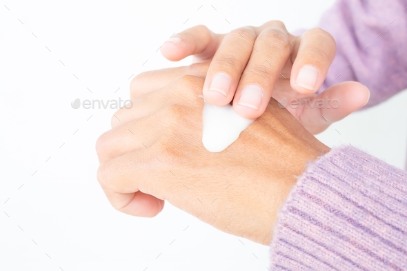 Woman applying Moisturizer lotion on hand. to prevent dry skin protect from radiation UV A, UV B.
