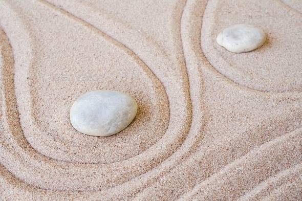 Zen garden stone Japanese on raked sand.
