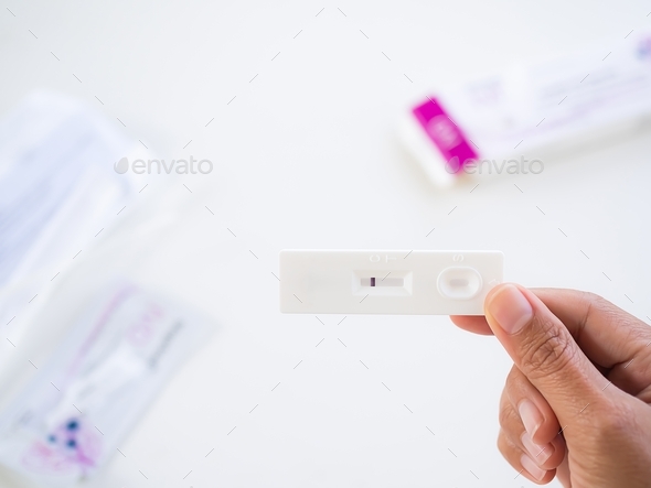 Finger holding Antigen test kit for testing virus. test results not infected with covid-19. healthca