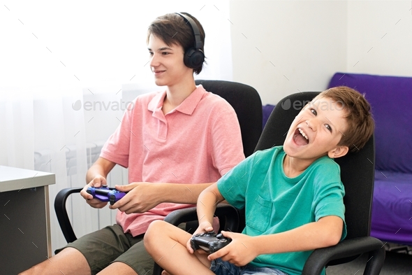 Kids emotions. Teenagers at home playing on line epic games