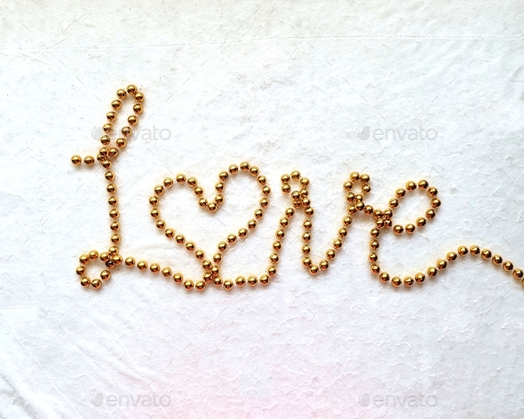 Love,word made with gold lettering on white background