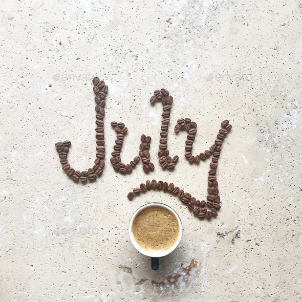 July,coffee bean text on stone table with coffee drink