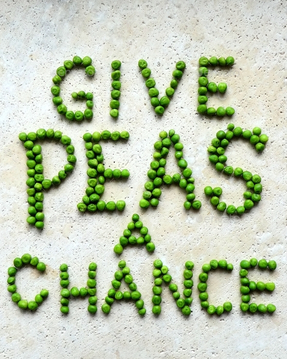 Creative food quote made with green peas on stone table
