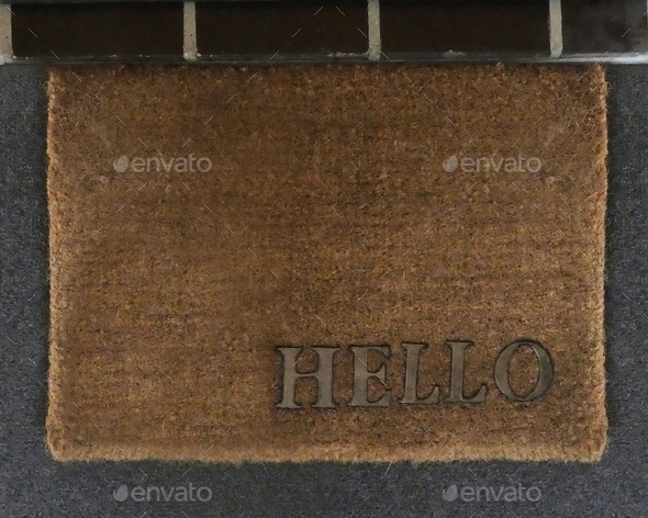 Hello,words on brown mat on floor in front of door entrance