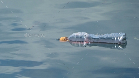 plastic bottle floating in water,pollution,lost at sea